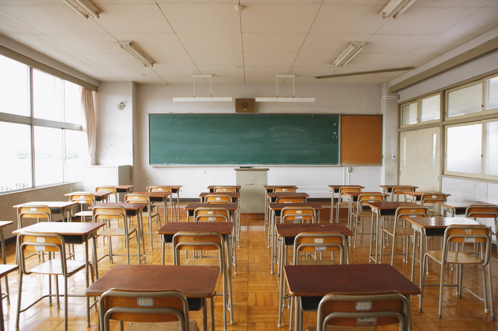 Empty Classroom with Desks and Chalkboard